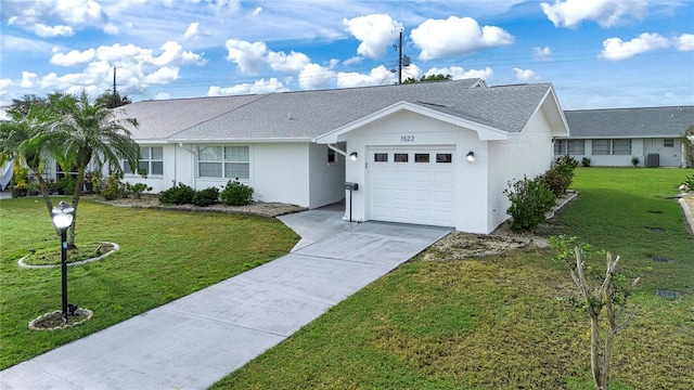 ranch-style home with a garage and a front lawn