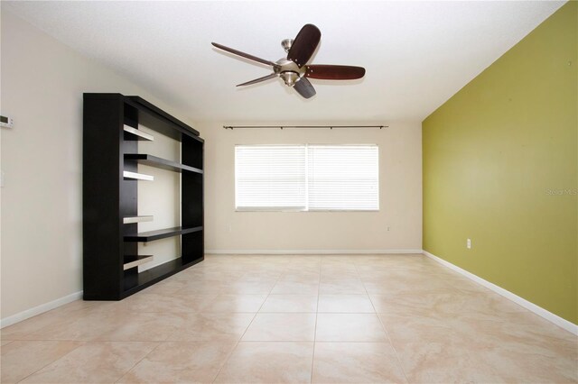 interior space with ceiling fan and light tile patterned flooring