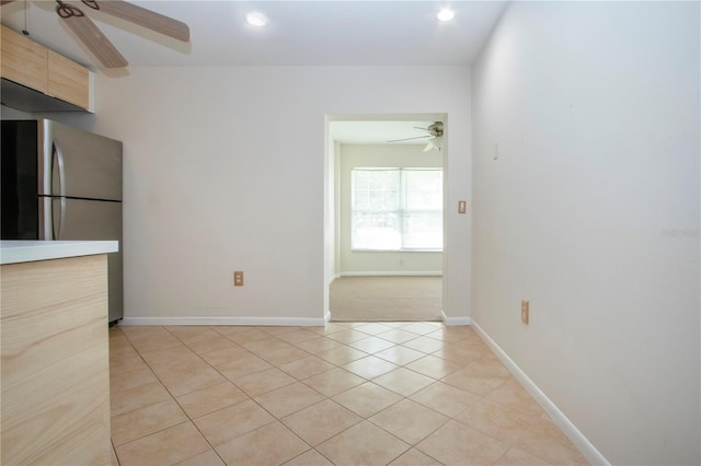 unfurnished room featuring ceiling fan and light tile patterned flooring