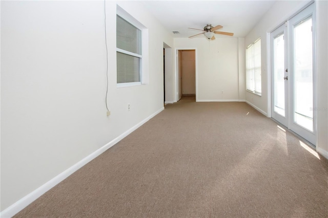 carpeted spare room with ceiling fan