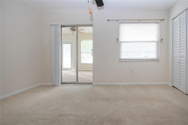 carpeted empty room with ceiling fan