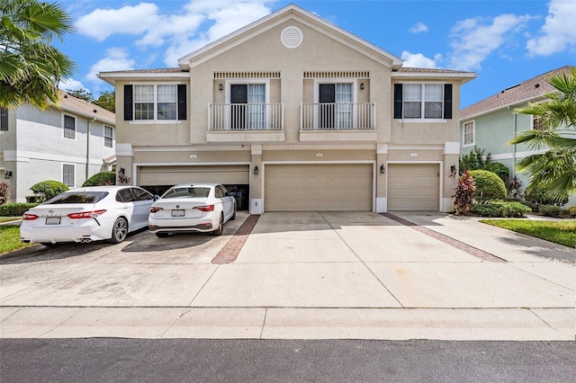 view of front facade featuring a balcony and a garage