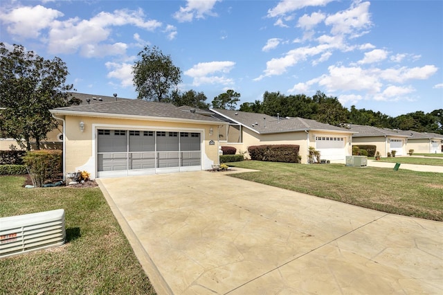 ranch-style home with a front lawn, central AC unit, and a garage