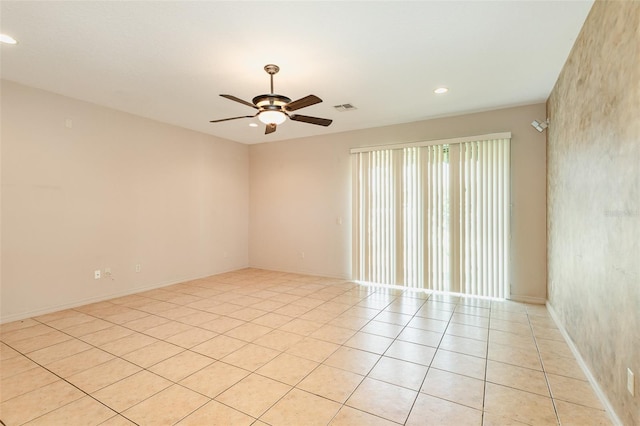 tiled empty room with ceiling fan