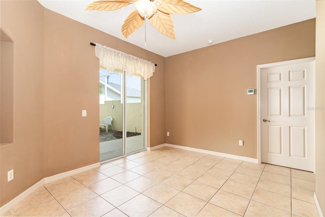 spare room featuring light tile patterned floors and ceiling fan