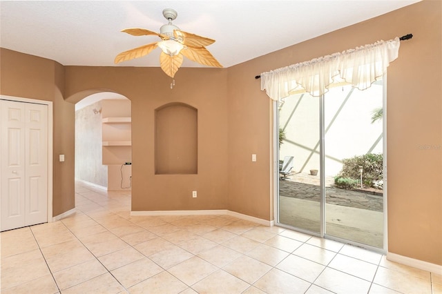 empty room with light tile patterned flooring and ceiling fan