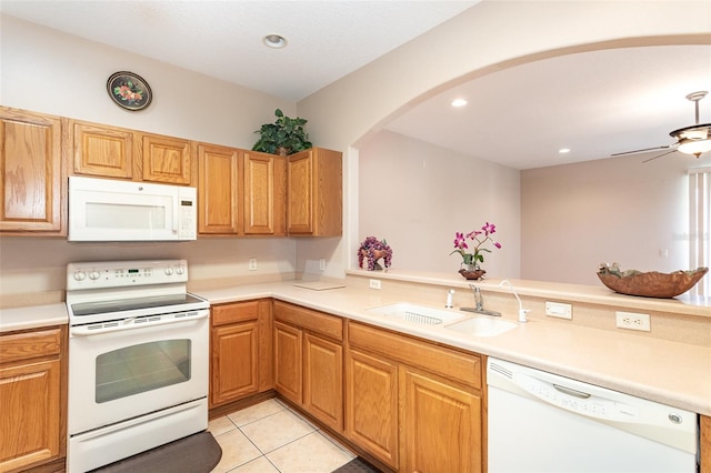 kitchen featuring white appliances, kitchen peninsula, light tile patterned flooring, and sink