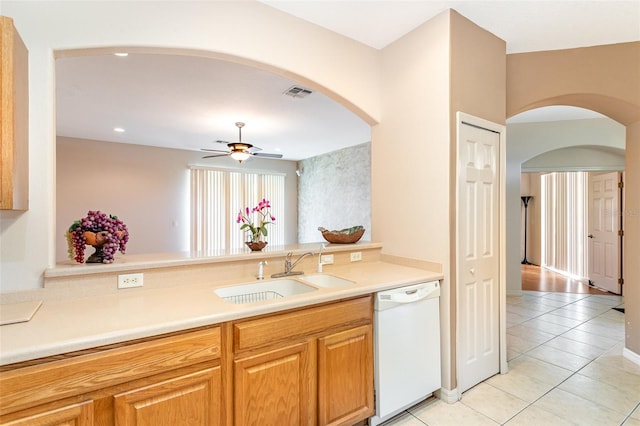 kitchen with light tile patterned floors, sink, white dishwasher, and ceiling fan