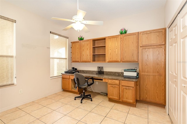 tiled office with built in desk and ceiling fan