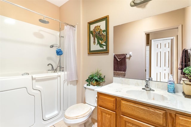 bathroom featuring tile patterned flooring, vanity, and toilet