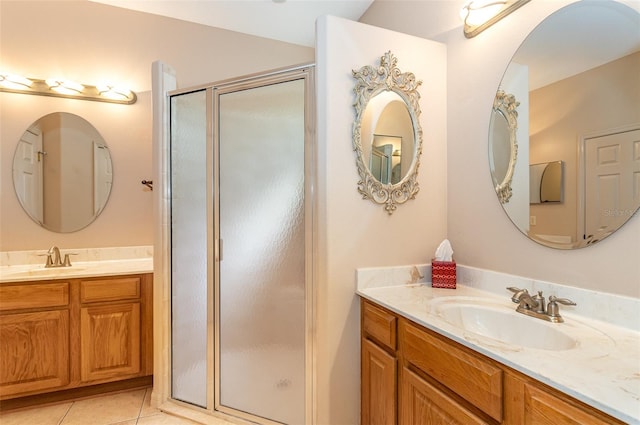 bathroom featuring tile patterned flooring, walk in shower, and vanity