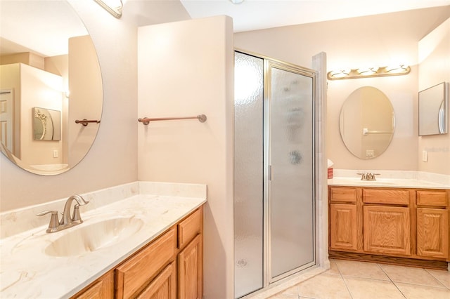 bathroom featuring tile patterned floors, an enclosed shower, and vanity