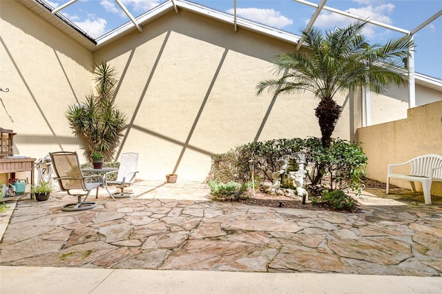 view of patio with a lanai