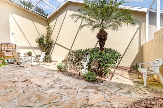 view of patio with glass enclosure