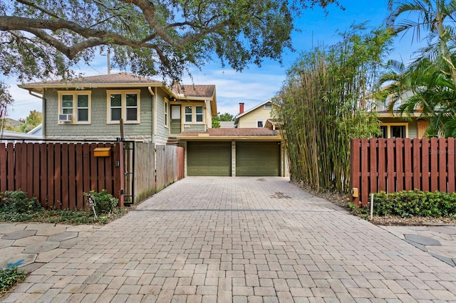 view of home's exterior with cooling unit, an outbuilding, and a garage