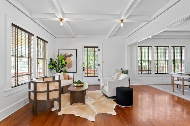 living area featuring beam ceiling and hardwood / wood-style flooring