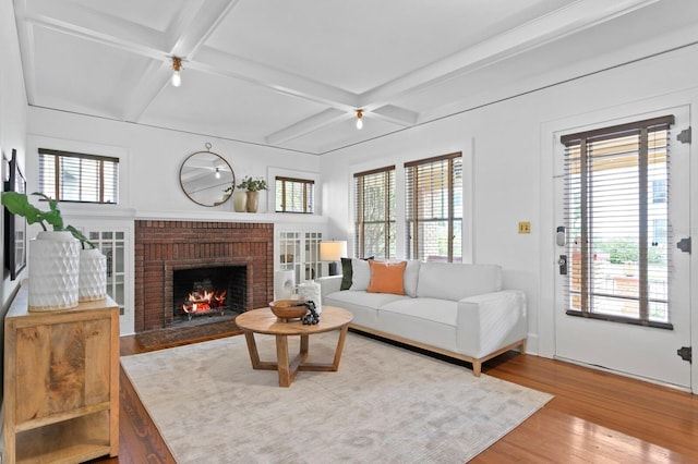 living room featuring a healthy amount of sunlight and a brick fireplace