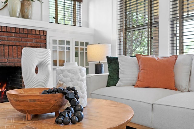 living room with a healthy amount of sunlight, a fireplace, and wood-type flooring