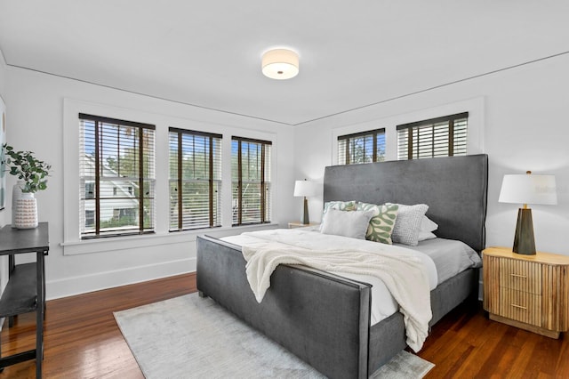 bedroom with dark wood-type flooring