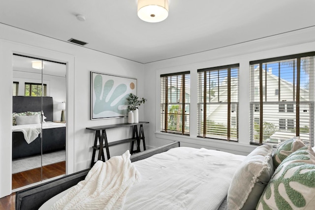 bedroom with a closet and hardwood / wood-style floors