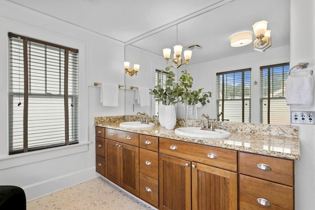 bathroom with a chandelier and vanity