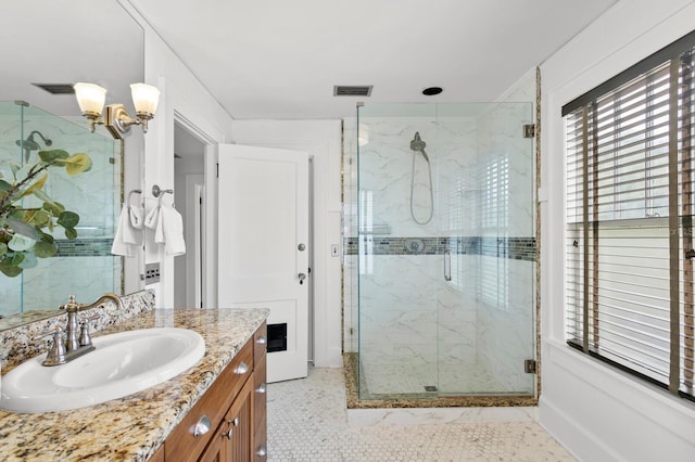 bathroom featuring vanity and an enclosed shower