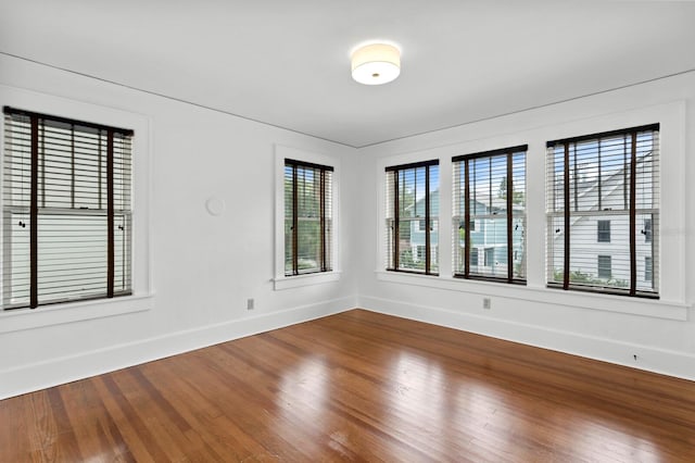 unfurnished room with hardwood / wood-style floors