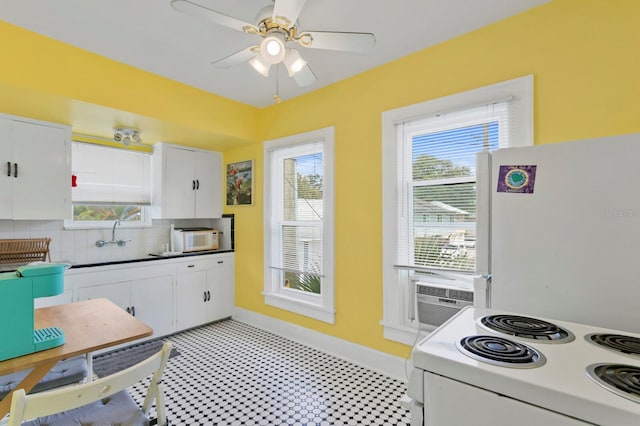 kitchen with backsplash, white appliances, white cabinetry, and ceiling fan