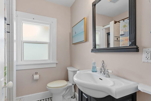 bathroom featuring walk in shower, vanity, and toilet