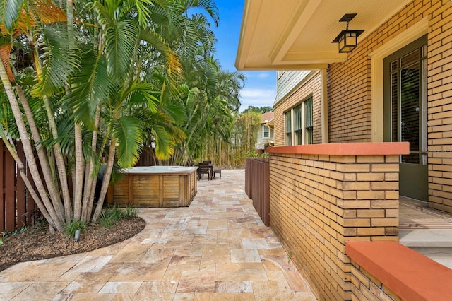 view of patio / terrace with a hot tub