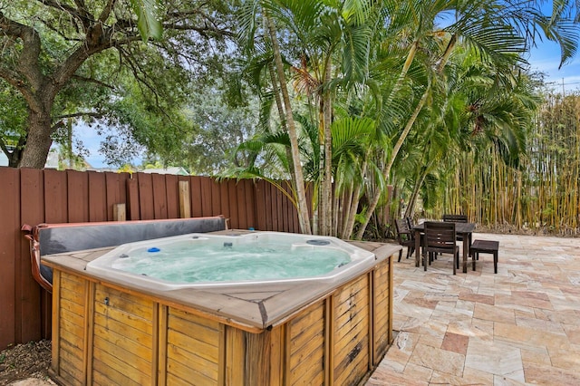 view of pool with a patio and a hot tub