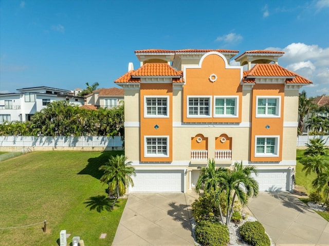 mediterranean / spanish-style home with a front yard and a garage