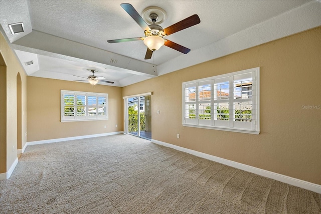 spare room with ceiling fan, carpet flooring, and a textured ceiling