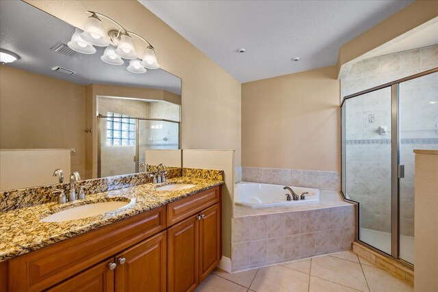 bathroom featuring a textured ceiling, tile patterned flooring, vanity, and separate shower and tub