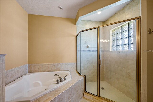 bathroom with a textured ceiling and plus walk in shower