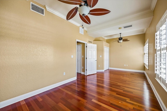 unfurnished room with ornamental molding, ceiling fan, and dark wood-type flooring