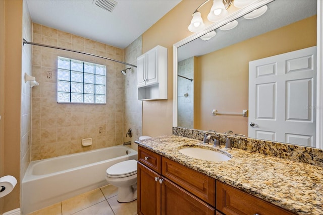 bathroom with bathtub / shower combination, visible vents, toilet, vanity, and tile patterned flooring