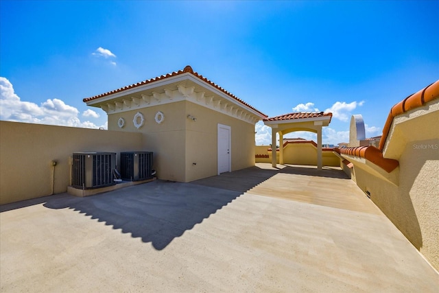 view of side of home with central AC unit and a patio area