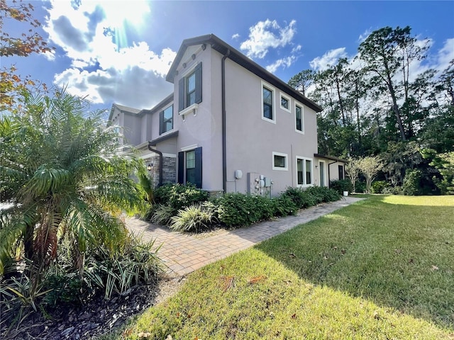 view of side of home featuring a yard