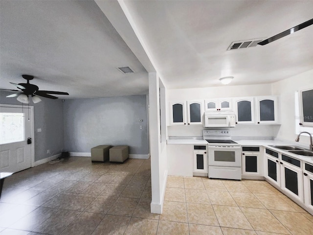 kitchen with sink, white cabinets, white appliances, light tile patterned floors, and ceiling fan