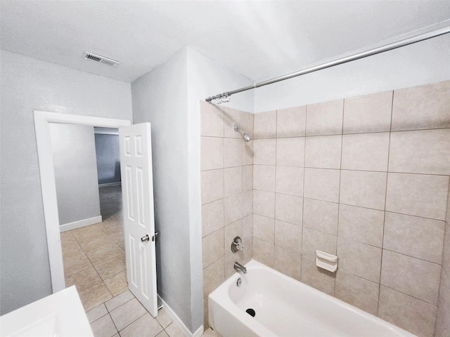 bathroom featuring tiled shower / bath combo and tile patterned floors