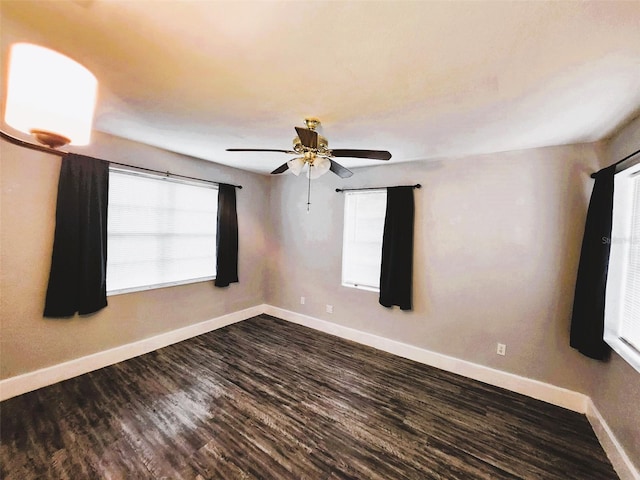 spare room featuring ceiling fan and dark wood-type flooring