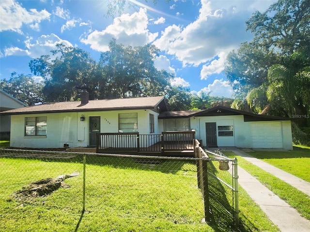 single story home featuring a garage and a front yard