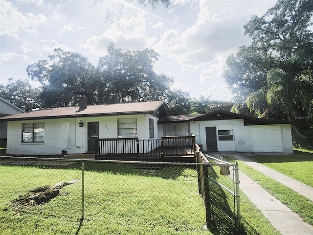 view of front of house with a garage and a front lawn