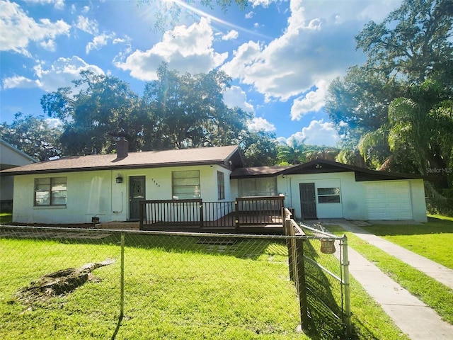 ranch-style house with a front yard, a garage, and a deck