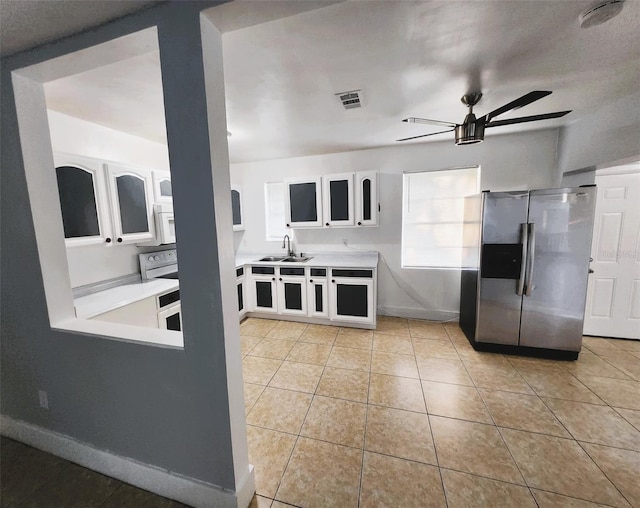 kitchen featuring ceiling fan, white cabinets, sink, light tile patterned floors, and stainless steel refrigerator with ice dispenser