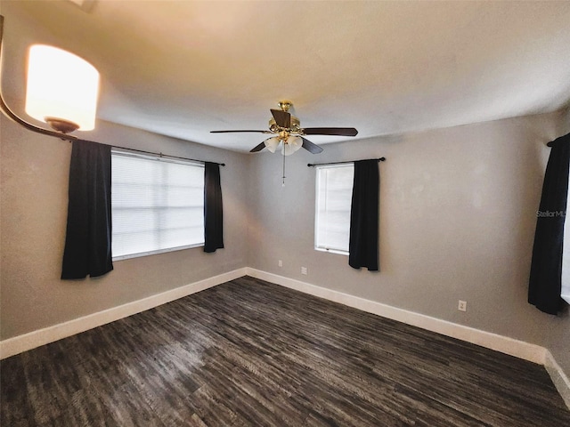 spare room featuring dark hardwood / wood-style floors and ceiling fan