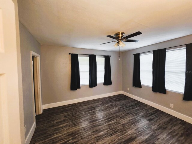 unfurnished room with ceiling fan and dark hardwood / wood-style floors