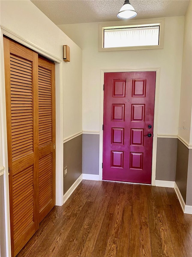 entrance foyer featuring a textured ceiling and dark hardwood / wood-style floors