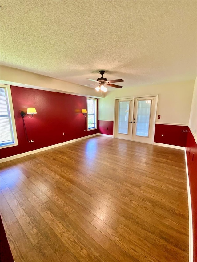 unfurnished room featuring ceiling fan, a textured ceiling, and hardwood / wood-style floors